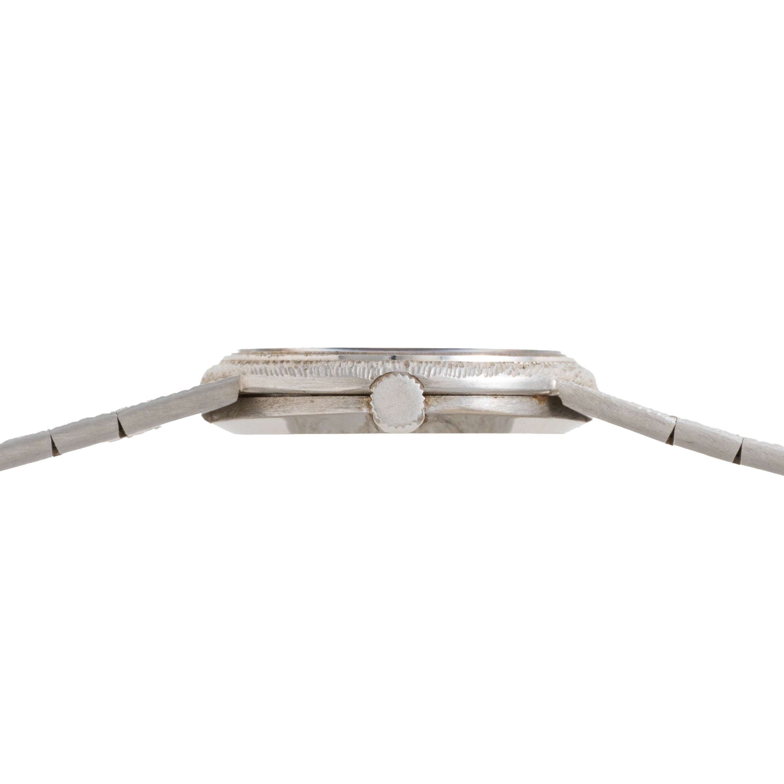 Side view of the Piaget White Gold Lapis Lazuli Dress Watch, featuring a round crown and metal band, displayed against a white background.