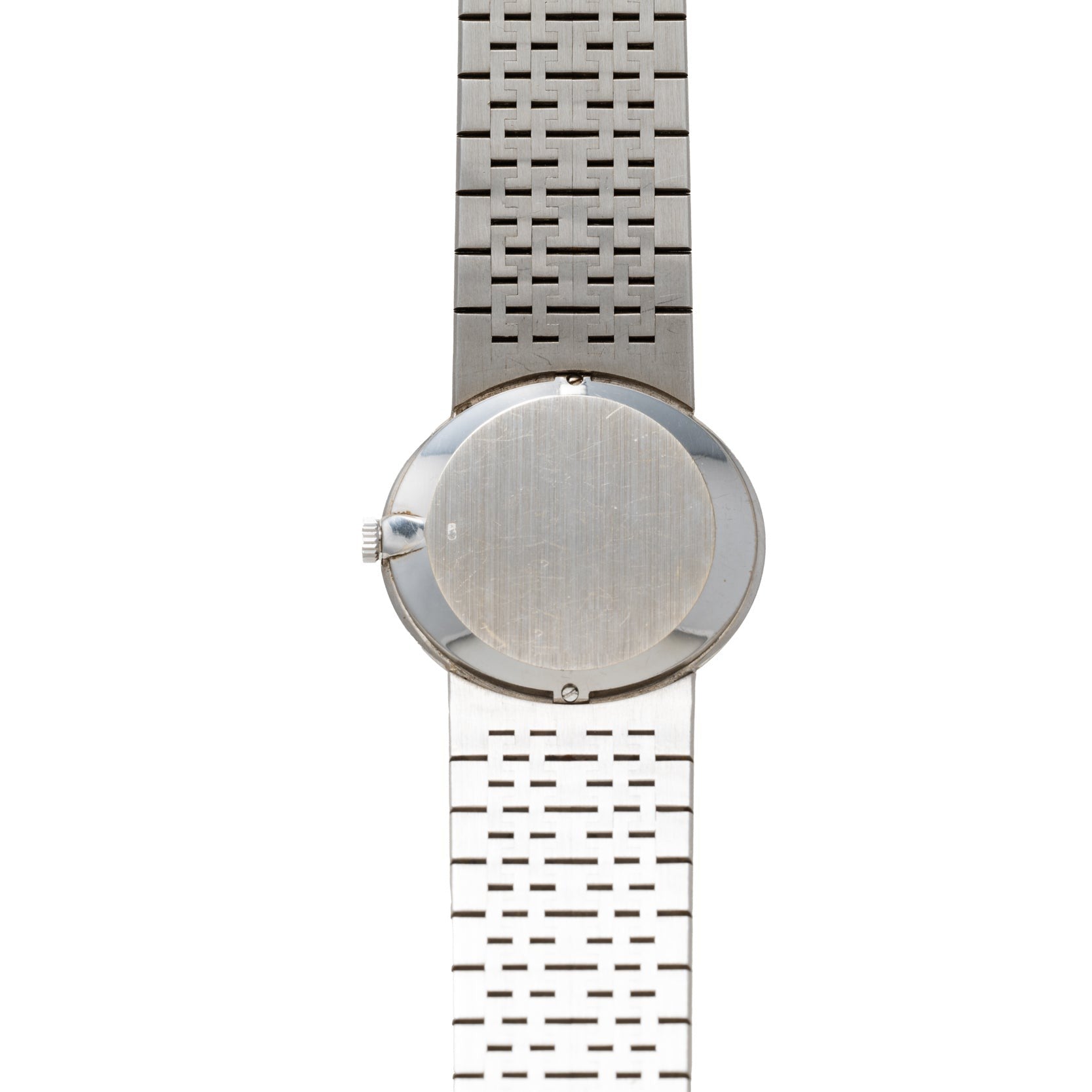 Piaget White Gold Lapis Lazuli Dress Watch displayed with its back case and geometric-patterned metal band, set against a white background.