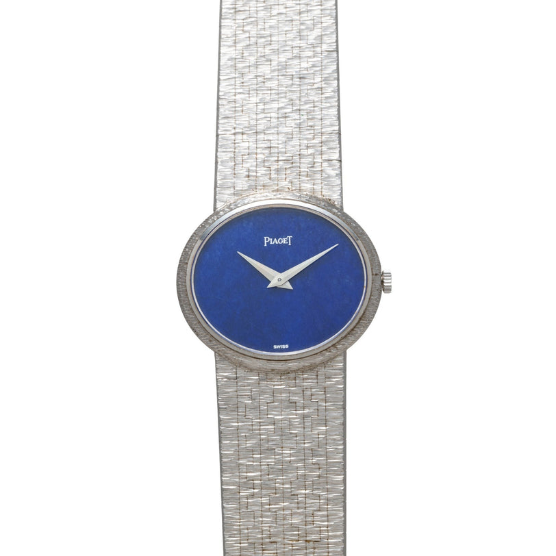 A white gold Lapis Lazuli dress watch by Piaget featuring a textured band and a blue lapis lazuli face.