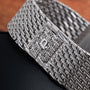 Close-up of a textured white gold watch band from the Piaget Onyx Dial White Gold Dress Watch, featuring a clasp engraved with the letter P.