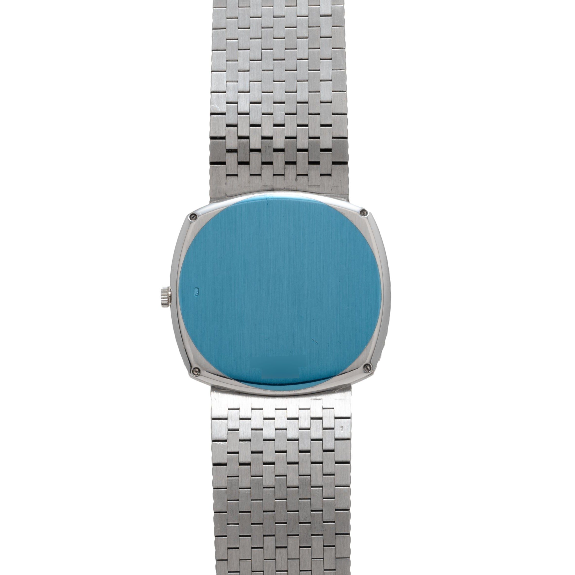 The Piaget Sqound White Gold Dress Watch features a blank blue face and a woven metal band, displayed against a white background.