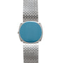 The Piaget Sqound White Gold Dress Watch features a blank blue face and a woven metal band, displayed against a white background.