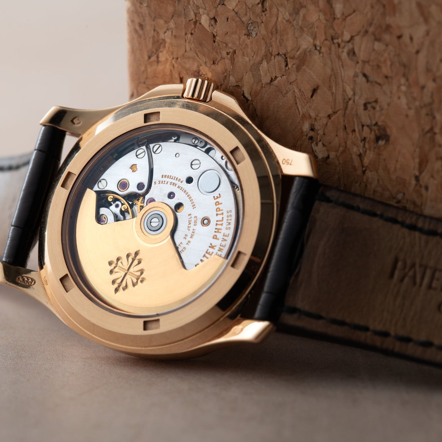 Close-up of the Patek Philippe Aquanaut’s exposed movement, showcasing visible gears and engravings, paired with a leather strap.