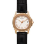 Patek Philippe Aquanaut watch with Roman numerals, black leather strap, and date display at 3 o’clock.