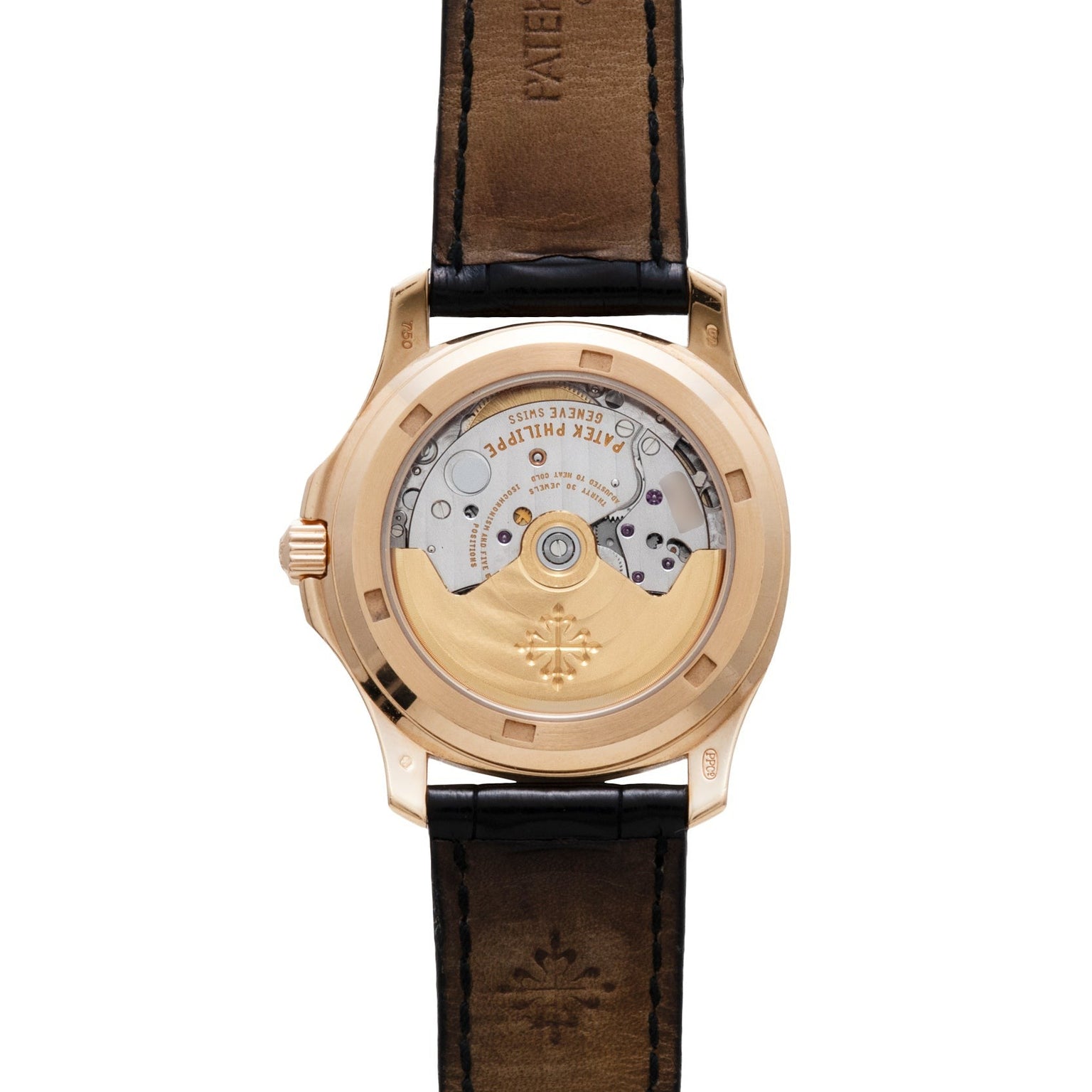 Back view of the Patek Philippe Aquanaut showcasing its gold movement and black leather strap.