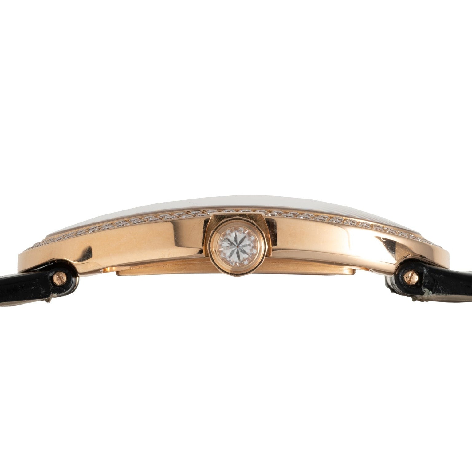 Side view of the Cartier Baignoire Jumbo gold case featuring a diamond-set crown and black leather straps.