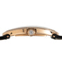 Side view of the Cartier Baignoire Jumbo gold case featuring a diamond-set crown and black leather straps.