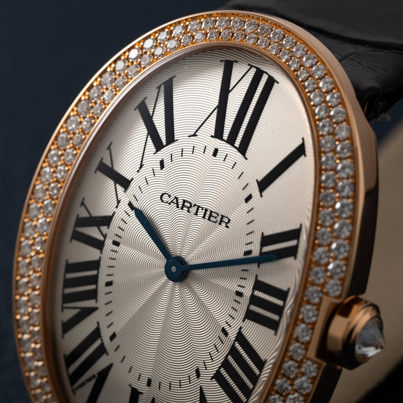 Close-up of the Cartier Baignoire Jumbo watch featuring Roman numerals and a diamond-studded gold bezel.