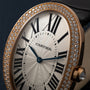 Close-up of the Cartier Baignoire Jumbo watch featuring Roman numerals and a diamond-studded gold bezel.
