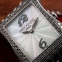 Close-up of the Patek Philippe Gondolo Ladies watch featuring a diamond-studded bezel, silver patterned face, and metallic hands.