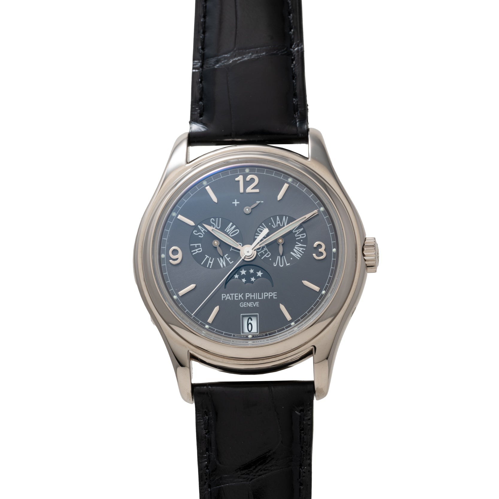 A Patek Philippe Annual Calendar Moonphase wristwatch featuring a black leather strap and dark dial with date and calendar functions.