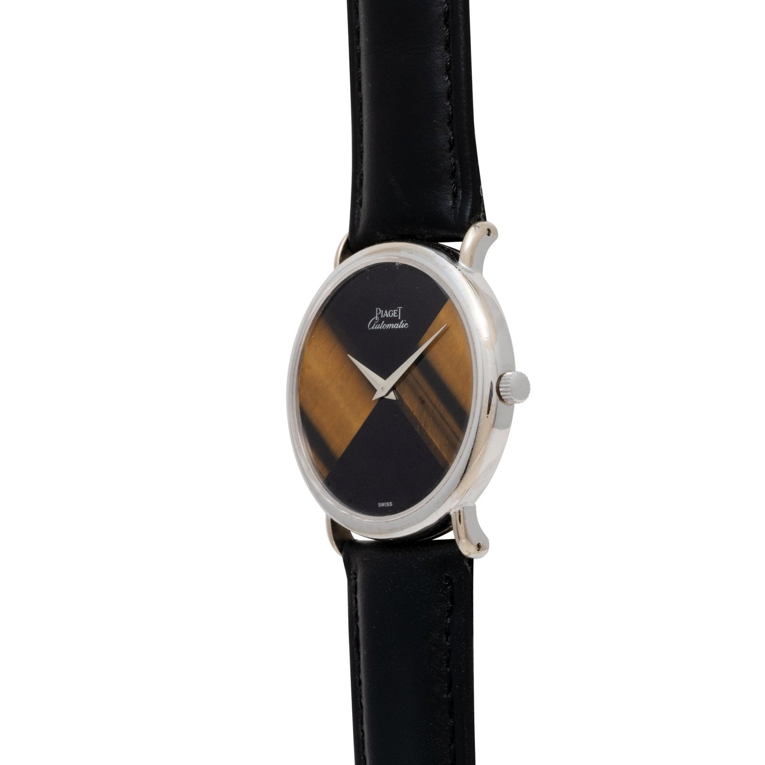 The Piaget Tigers Eye Onyx Dress Watch features an oval silver case, black leather strap, and a geometric two-tone brown and black dial.