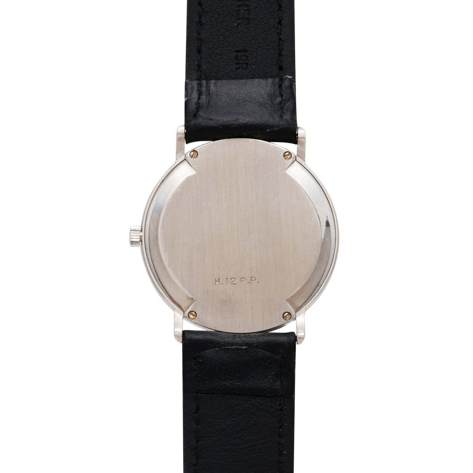 Back view of the Piaget Tigers Eye Onyx Dress Watch in silver with a black leather strap and H.12 G.P.P. engraving.