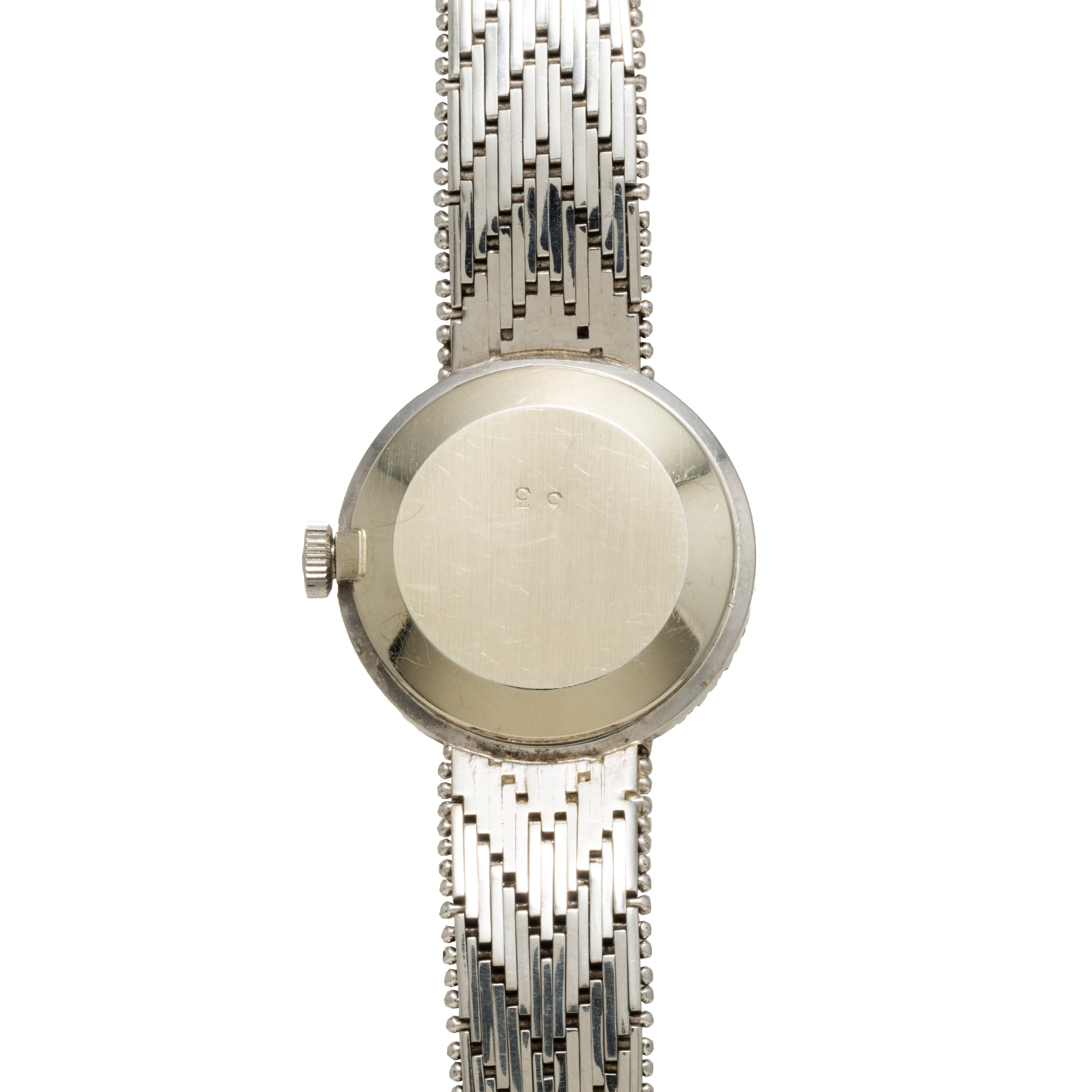 The Zenith Ladies Cocktail Watch is displayed from the back, showcasing its round case and textured metal band.