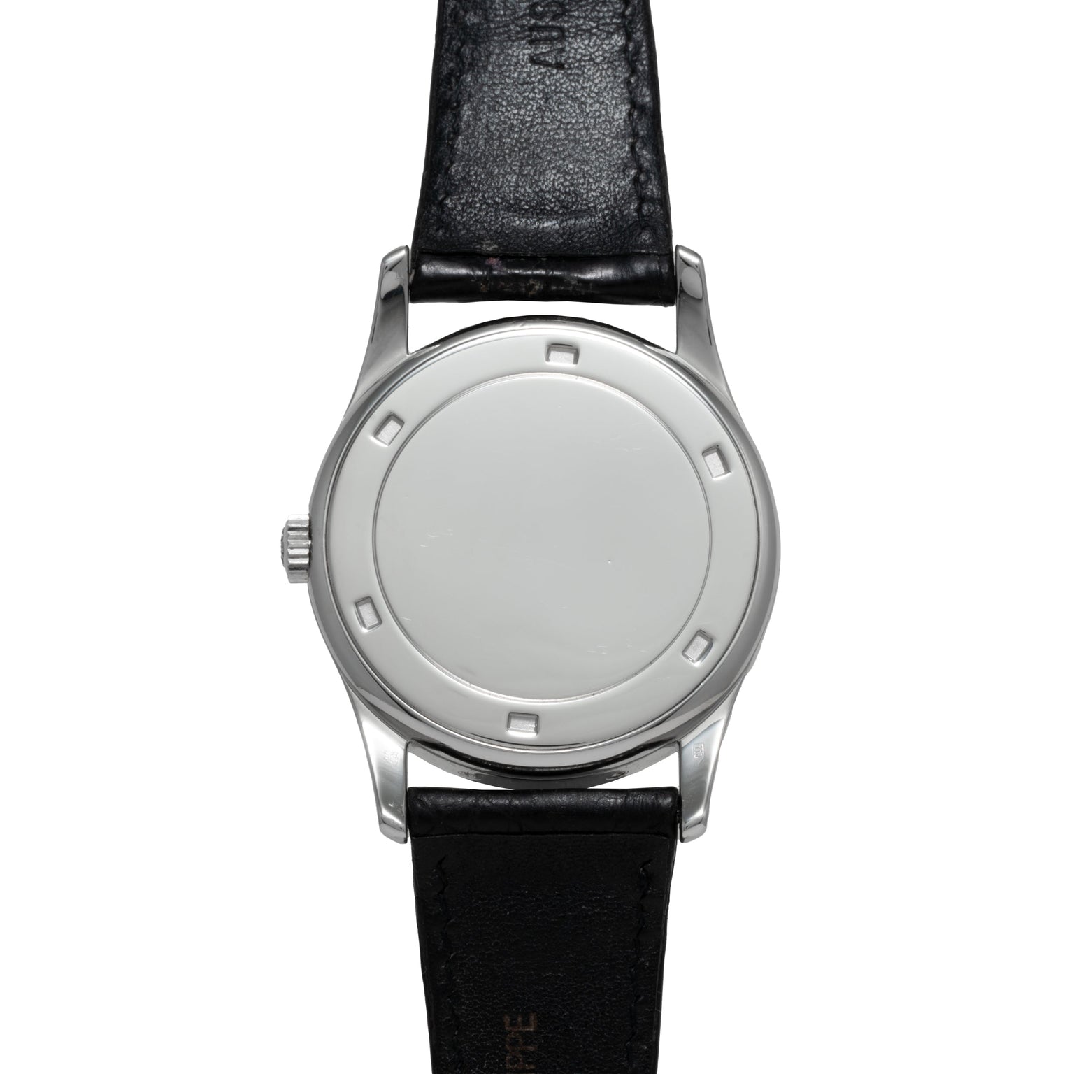 The Patek Philippe Retrograde Perpetual Calendar features a silver case, a minimalist white dial, and a black leather strap with no visible numbers or hands.
