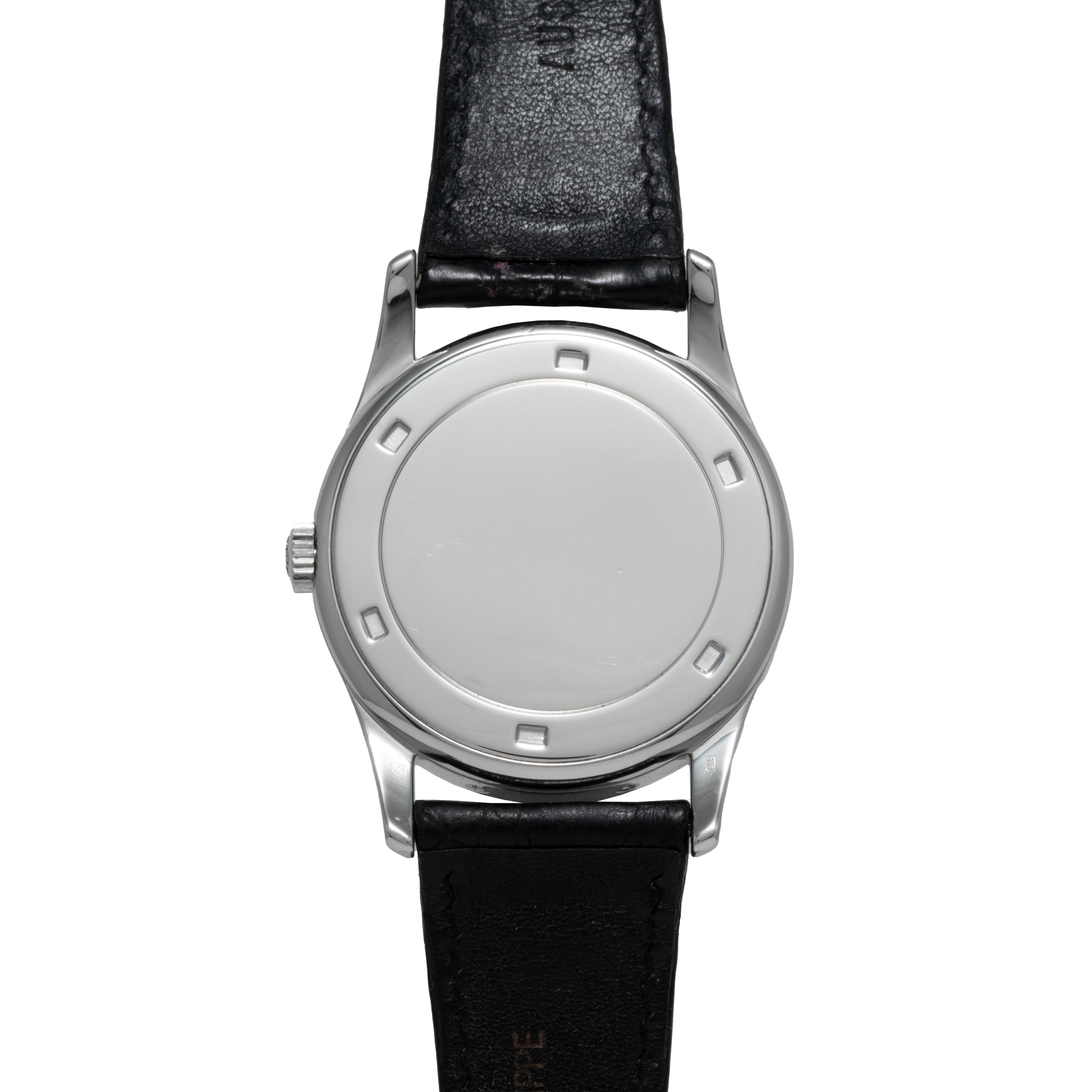 The Patek Philippe Retrograde Perpetual Calendar features a silver case, a minimalist white dial, and a black leather strap with no visible numbers or hands.