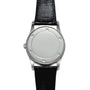 The Patek Philippe Retrograde Perpetual Calendar features a silver case, a minimalist white dial, and a black leather strap with no visible numbers or hands.