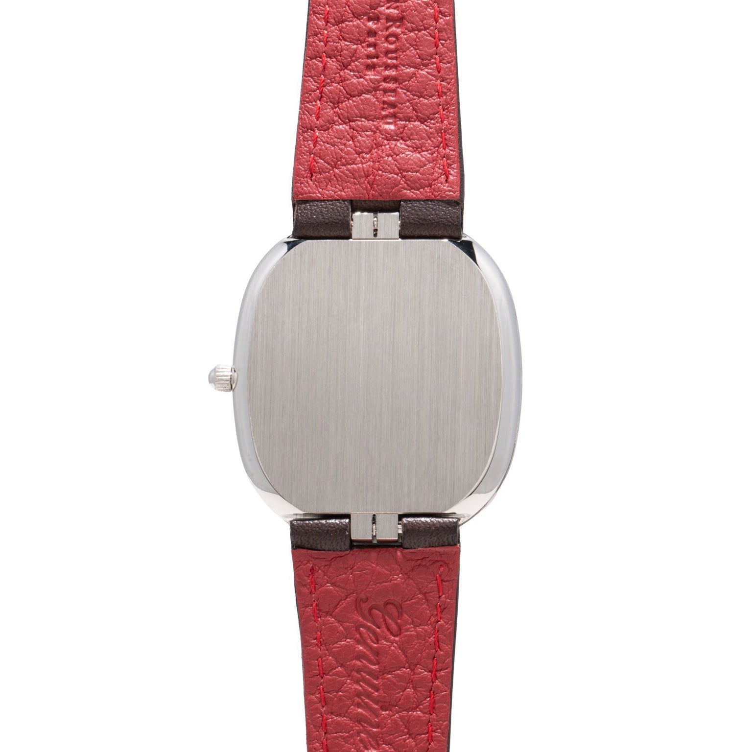 The Patek Philippe Ellipse wristwatch features a brushed metal case and a textured red leather strap, shown from the back.