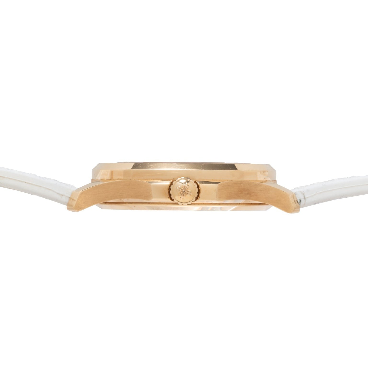 Side view of the Patek Philippe Aquanaut Ladies gold case wristwatch featuring a white leather strap and a center crown.