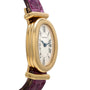 Cartier Baignoire watch featuring a gold oval case, Roman numerals, and a purple leather strap, displayed from an angled side view.