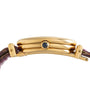 Side view of the Cartier Baignoire gold wristwatch featuring a round crown and a purple leather strap.