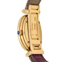 The Cartier Baignoire features an 18K-stamped gold back, a purple leather strap, and a blue cabochon crown.