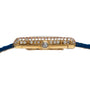 Side view of the Cartier Tank Louis Diamonds gold watch case with diamond accents and a blue leather strap.