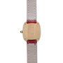 The Cartier Gondole Ladies watch features a gold case with a beige leather strap and red trim, shown from the back to display its engravings.