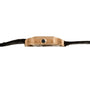 Side view of the Cartier Santos Mini, a thin gold wristwatch with a black strap and a small round crown on the right.