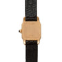 Back view of the Cartier Santos Mini watch featuring a gold case and black leather strap.
