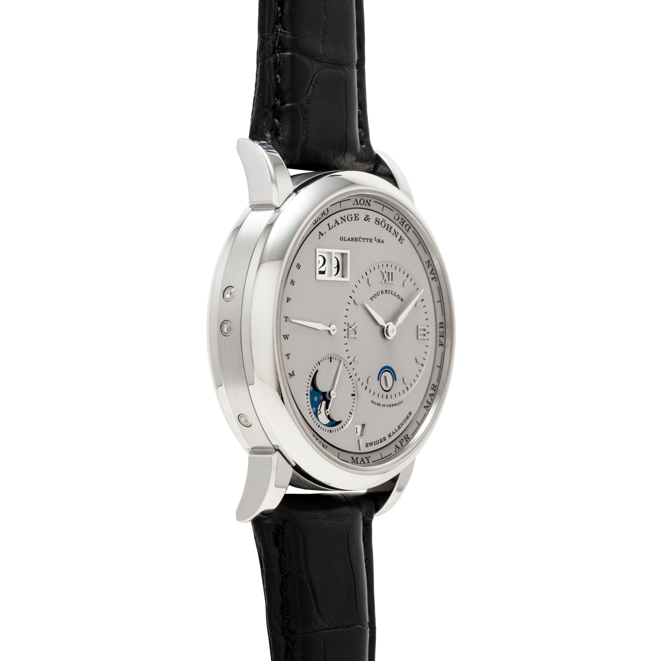 Side view of the Lange & Sohne Lange 1 Tourbillon Perpetual Calendar, a luxury silver wristwatch with a black leather strap and multiple dials on the face.