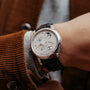 A close-up of a Lange & Sohne Lange 1 Tourbillon Perpetual Calendar luxury wristwatch on a persons wrist.