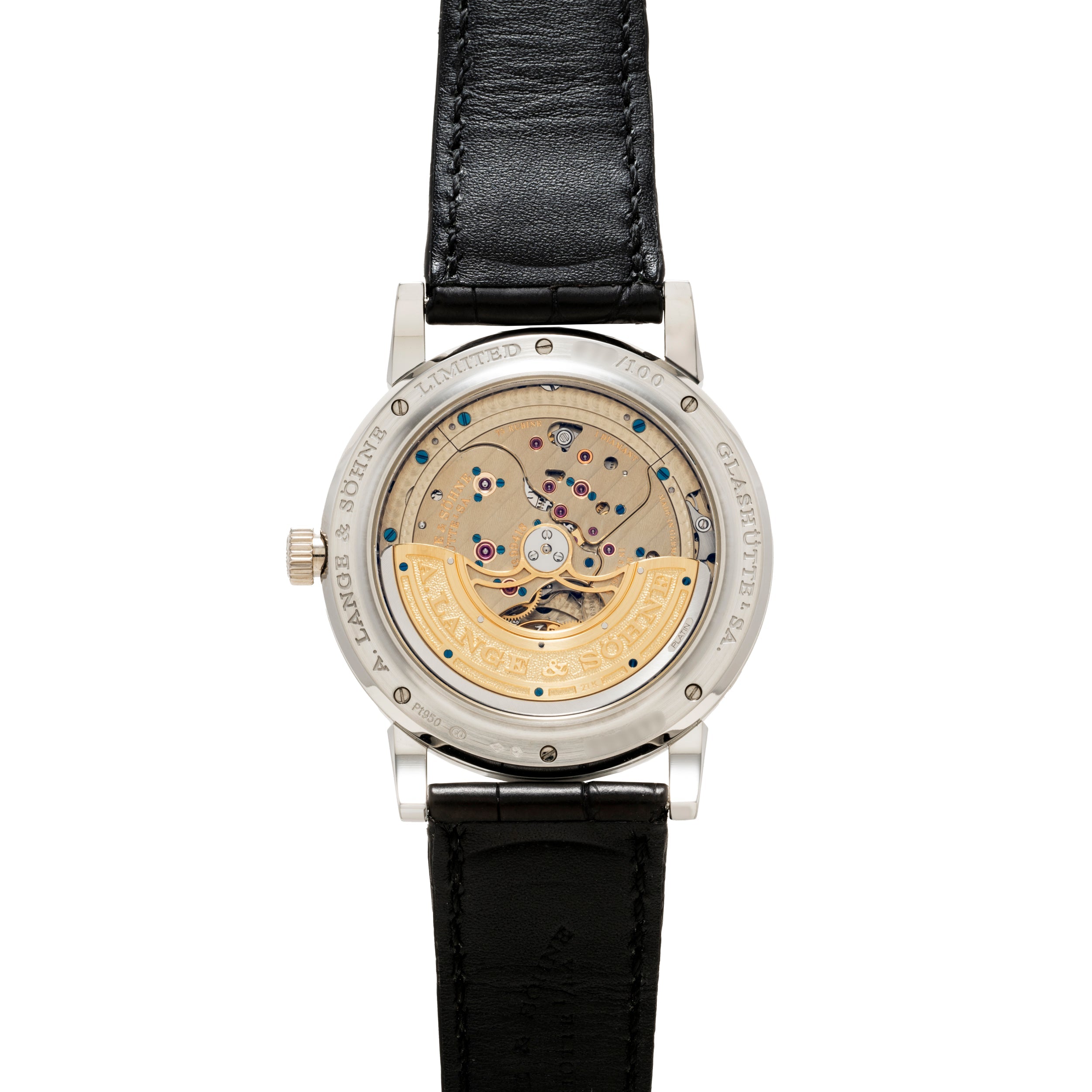 The Lange & Sohne Lange 1 Tourbillon Perpetual Calendar features a black leather strap and a transparent case back that displays its intricate gears and mechanisms.