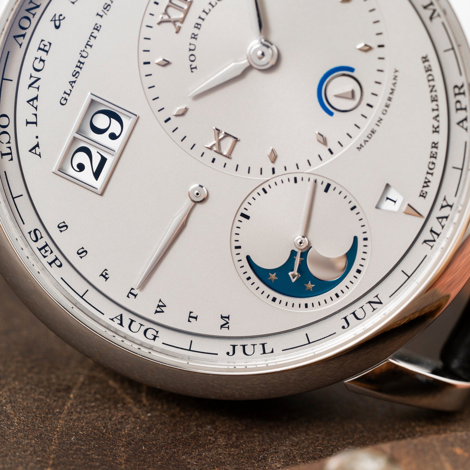 Close-up of the Lange & Sohne Lange 1 Tourbillon Perpetual Calendar, showcasing its silver dial with date, month, day, and moon phase displays.