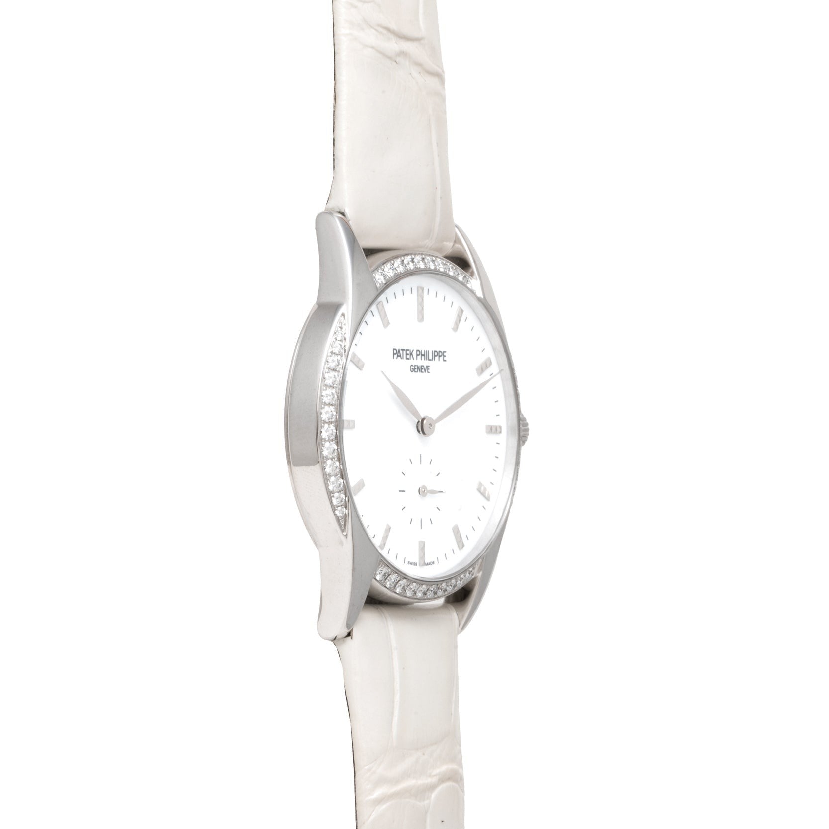 Side view of the Patek Philippe Calatrava watch featuring a white strap and diamond-set bezel, displayed on a white background.