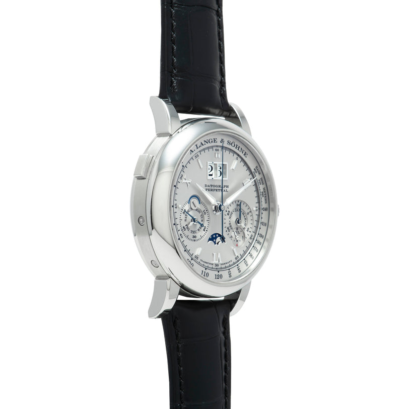 The Lange & Sohne Datograph Perpetual Calendar is a luxury silver wristwatch with a black leather strap, featuring multiple dials and a moonphase display.