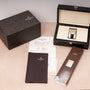 Patek Philippe Multi-Scale Chronograph with box, certificate, booklet, and accessories displayed on a light-colored surface.