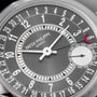 Close-up of a Patek Philippe Calatrava watch face featuring date numbers, hands, and a small seconds subdial.