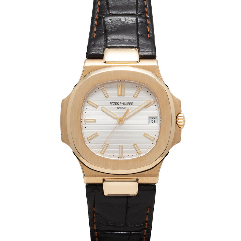 Patek Philippe Nautilus wristwatch with a white dial, date window, and black leather strap.