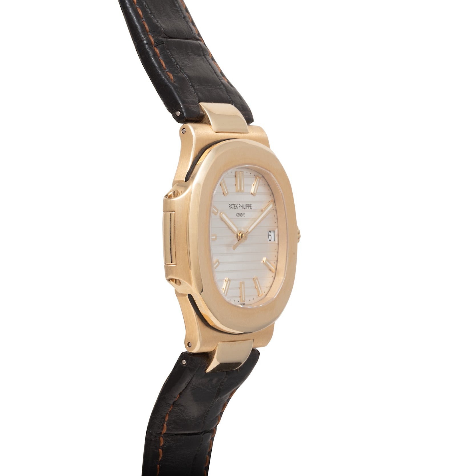 The Patek Philippe Nautilus wristwatch features a white dial and black leather strap, displayed from a side angle.