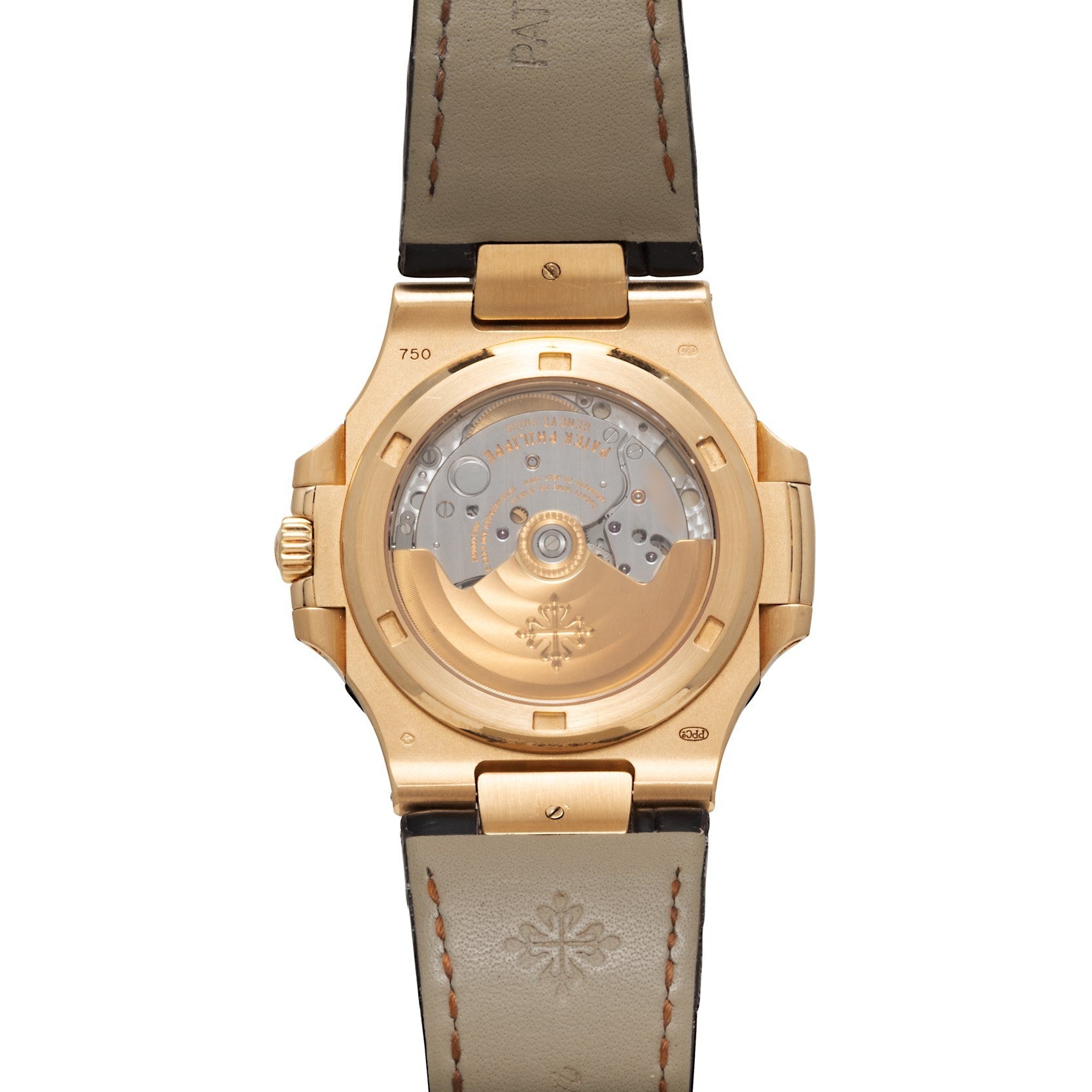 The back of a Patek Philippe Nautilus gold wristwatch showcases its visible mechanical movement and leather strap.