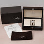 A Patek Philippe Ladies Complication watch in its box with certificate, cleaning cloth, and outer packaging displayed.