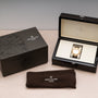 A Patek Philippe Nautilus watch displayed in an open box, accompanied by its outer box and a branded cloth.