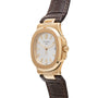 A Patek Philippe Nautilus wristwatch with a white dial and brown leather strap, displayed at an angle.