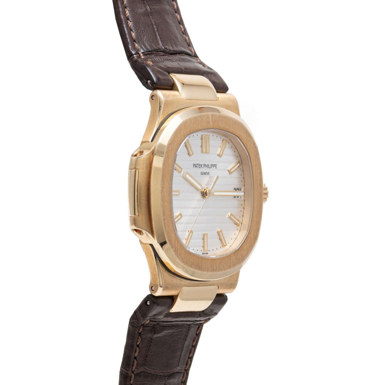 Patek Philippe Nautilus wristwatch with a brown leather strap, white dial, gold hour markers, and an angled view.