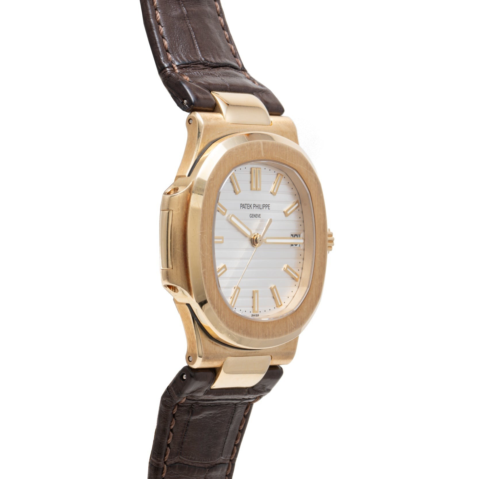 Patek Philippe Nautilus wristwatch with a brown leather strap, white dial, gold hour markers, and an angled view.