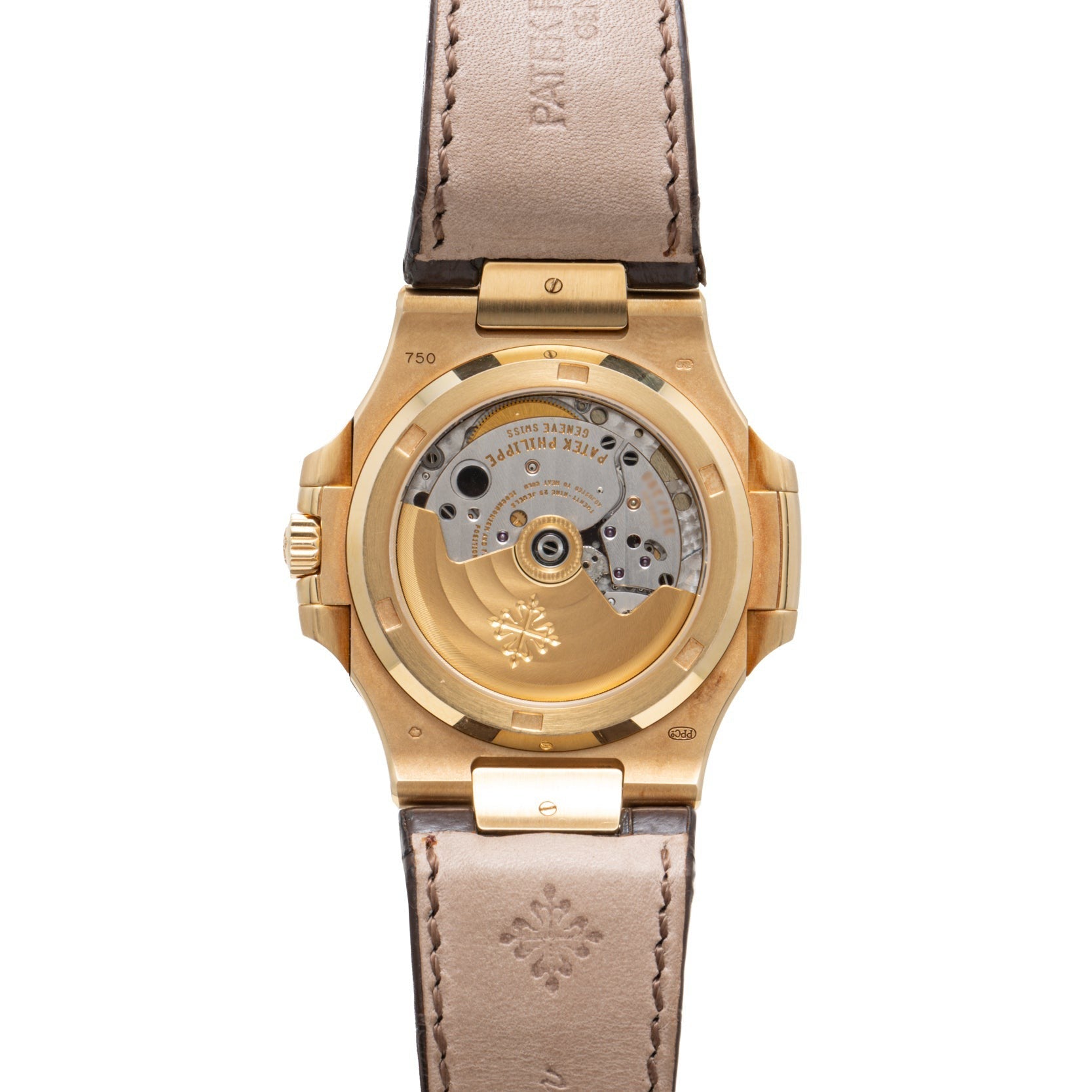 The Patek Philippe Nautilus features a gold case with an exhibition back displaying its mechanical movement, a brown leather strap, and engraved branding.