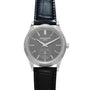 A Patek Philippe Calatrava wristwatch featuring a silver case, gray dial, and black leather strap.