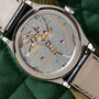 Close-up of the Patek Philippe Calatrava’s transparent case back, revealing its intricate mechanical movement and gears.