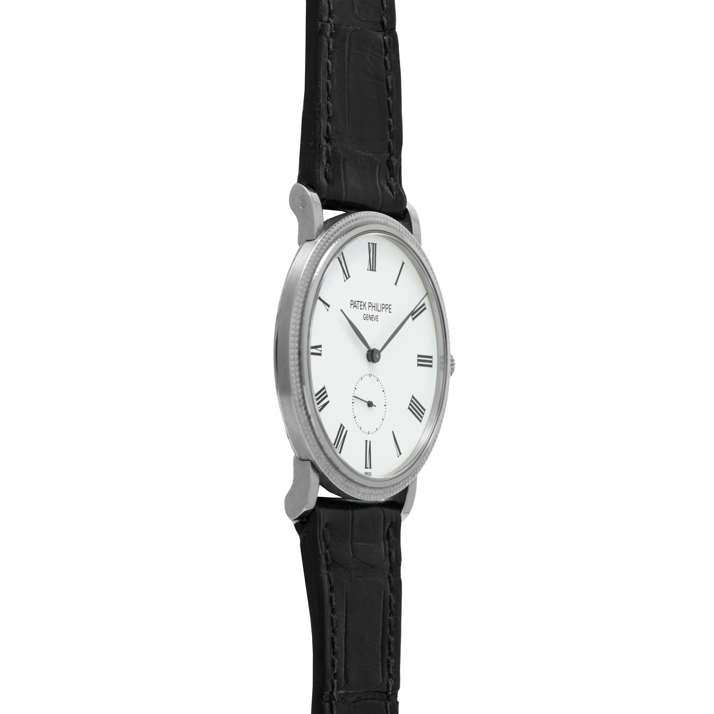 The Patek Philippe Calatrava is shown from the side, featuring a silver case, white dial with black Roman numerals, and a black leather strap.